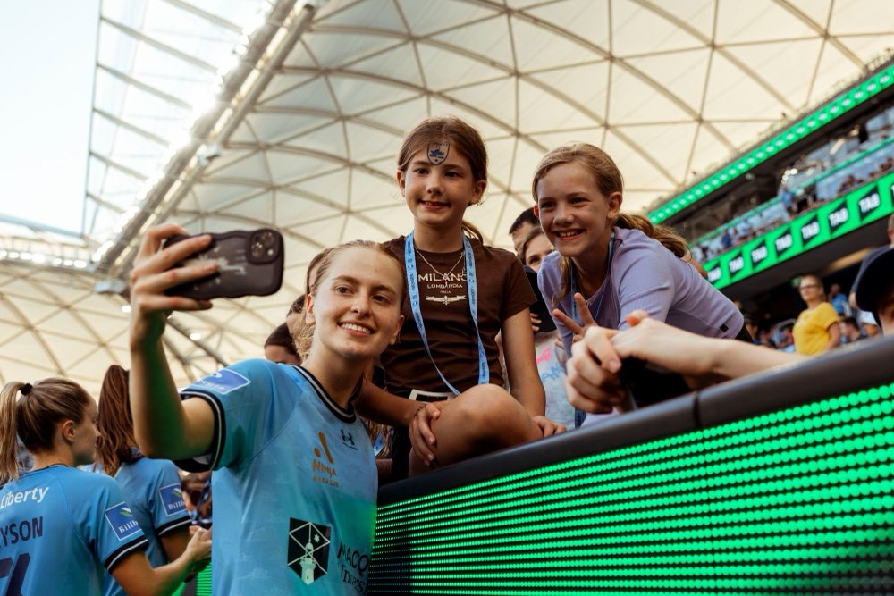 A Sydney FC player taking a selfie with young fans at Allianz Stadium